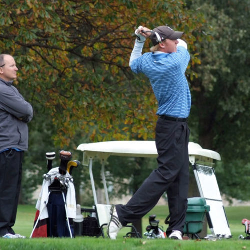 Coach Pint (left) looks on