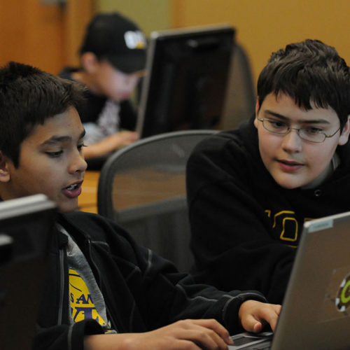 Two KICK Camp participants look over their work