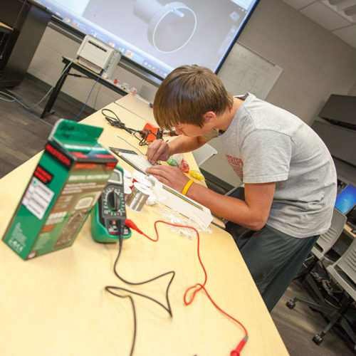 A Washington County Regional Center student works on a project