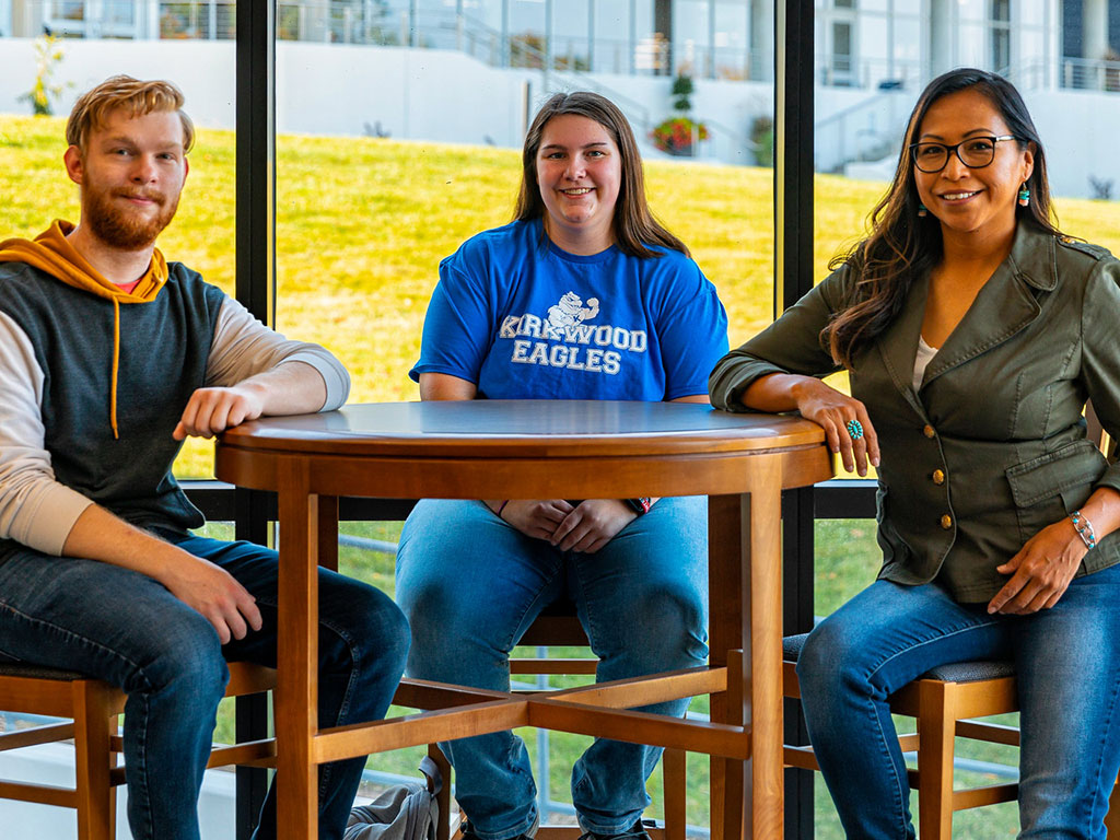Students-Sitting-in-Library-Looking-at-Camera-Featured