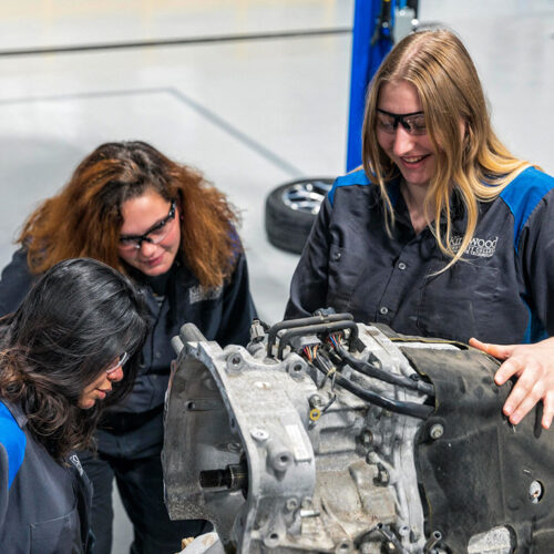 Female-Students-Working-on-a-Car-Featured