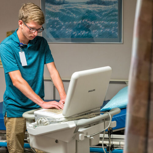 Young-Man-Working-in-a-Medical-Setting-Featured