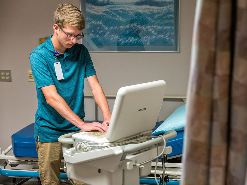 Young-Man-Working-in-a-Medical-Setting-Featured