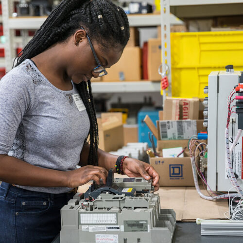 Young-Woman-Working-on-Electronics-Featured