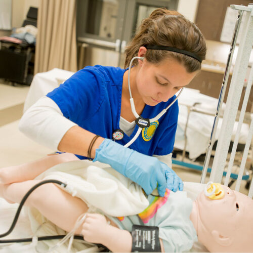 A-Nursing-Student-in-the-Sim-Center-Cares-for-a-Simulator-Featured