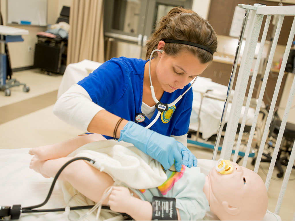 A-Nursing-Student-in-the-Sim-Center-Cares-for-a-Simulator-Featured