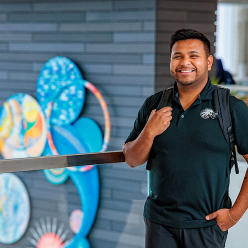 A-Student-Posing-for-a-Photo-in-Iowa-Hall-Featured