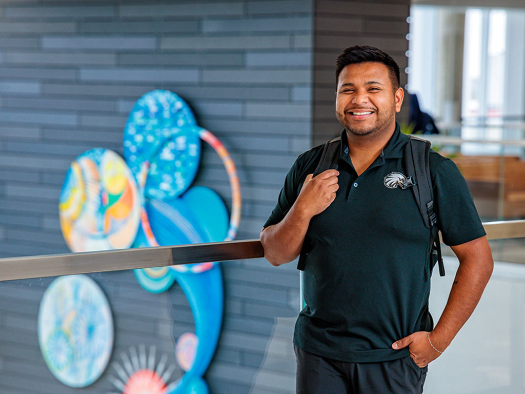 A-Student-Posing-for-a-Photo-in-Iowa-Hall-Featured