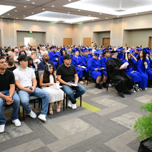 High-School-Completion-Graduation-Ceremony-Attendees-in-Their-Seats-Featured