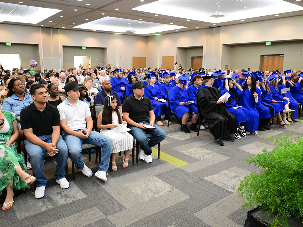 High-School-Completion-Graduation-Ceremony-Attendees-in-Their-Seats-Featured