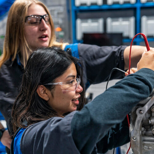 Automotive Students Work on a Car Featured