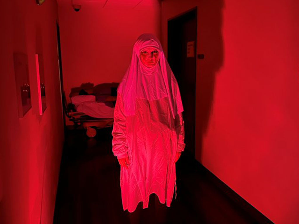 Spooky-Person-Standing-in-a-Red-Lit-Hallway-Featured